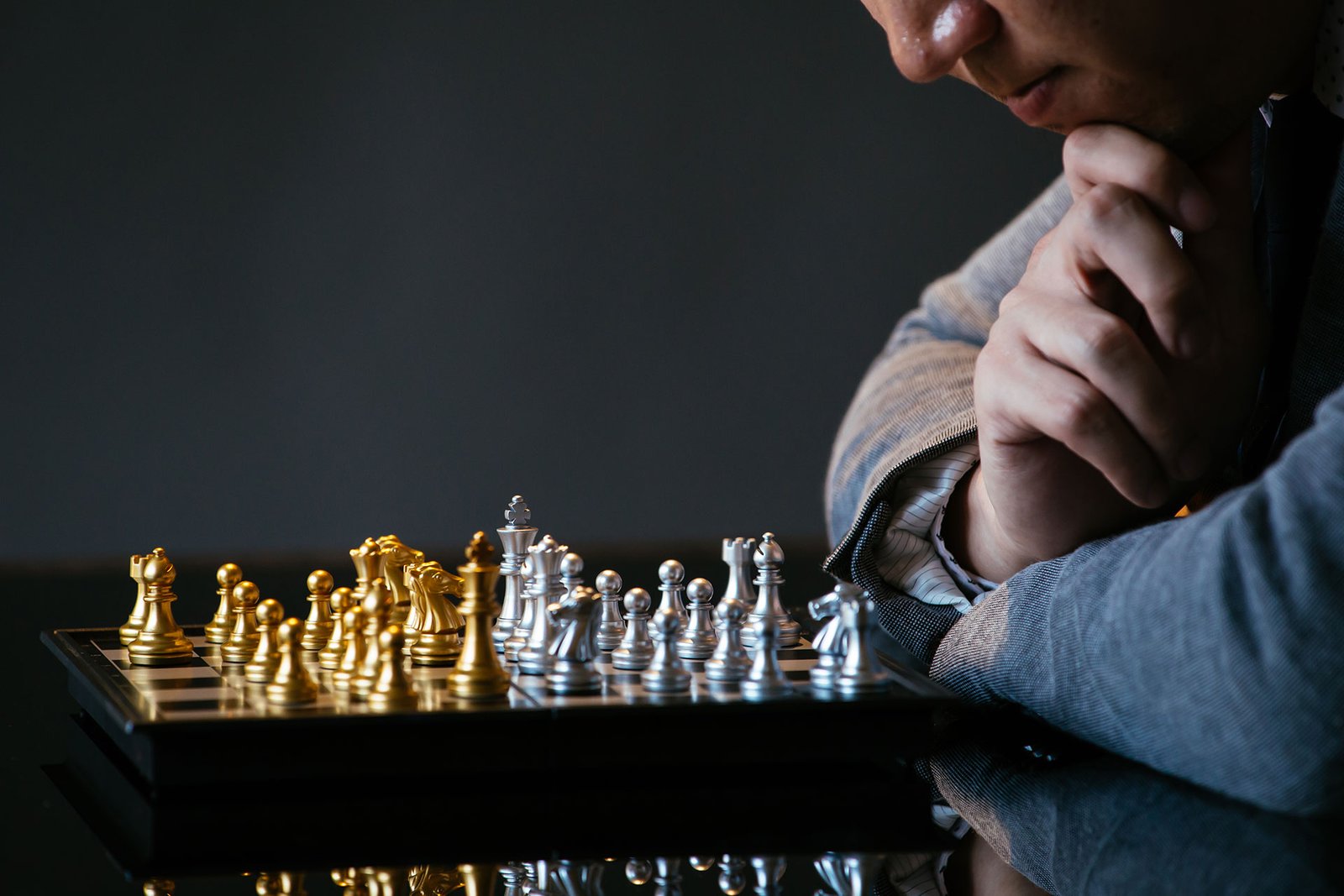 serious-businessman-playing-chess-and-thinking-ove-WFQ2J53.jpg
